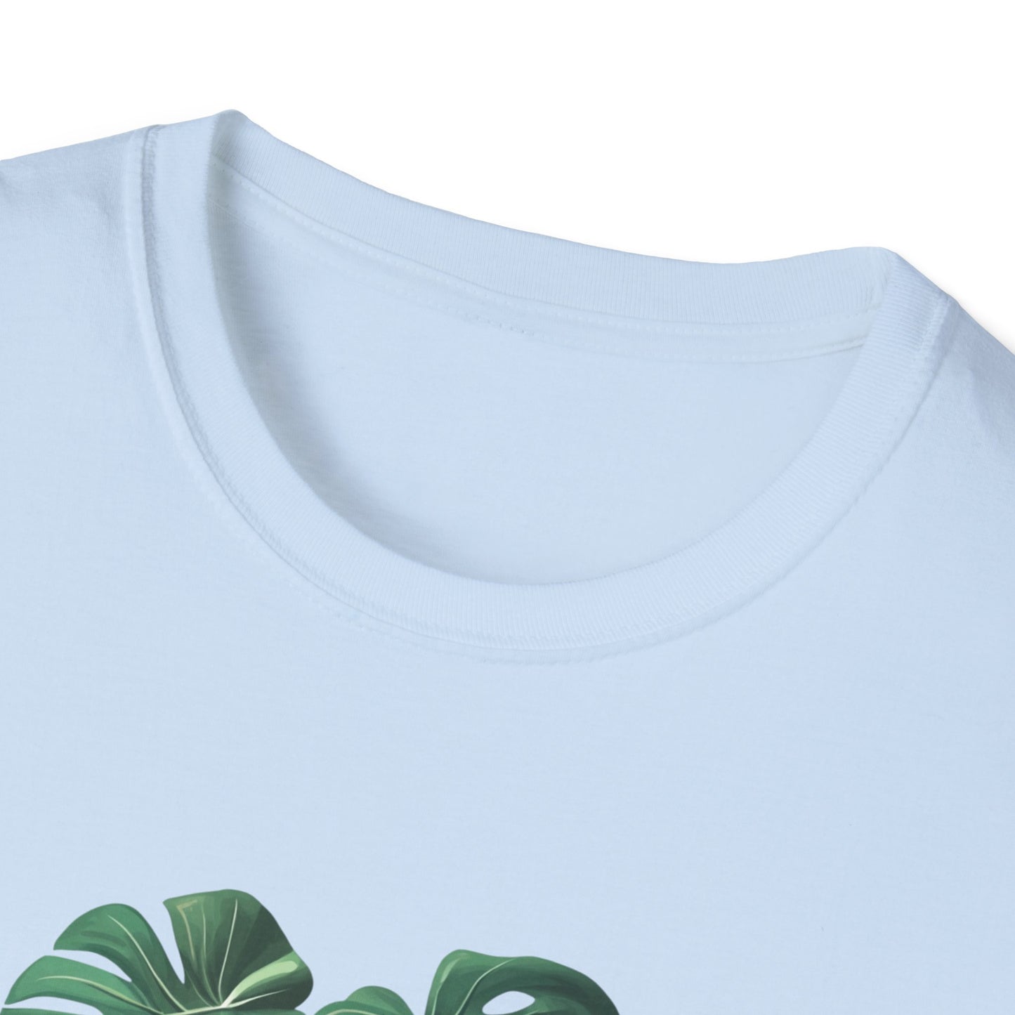 Close-up of a light blue monstera deliciosa t-shirt with vibrant leaf design and soft fabric