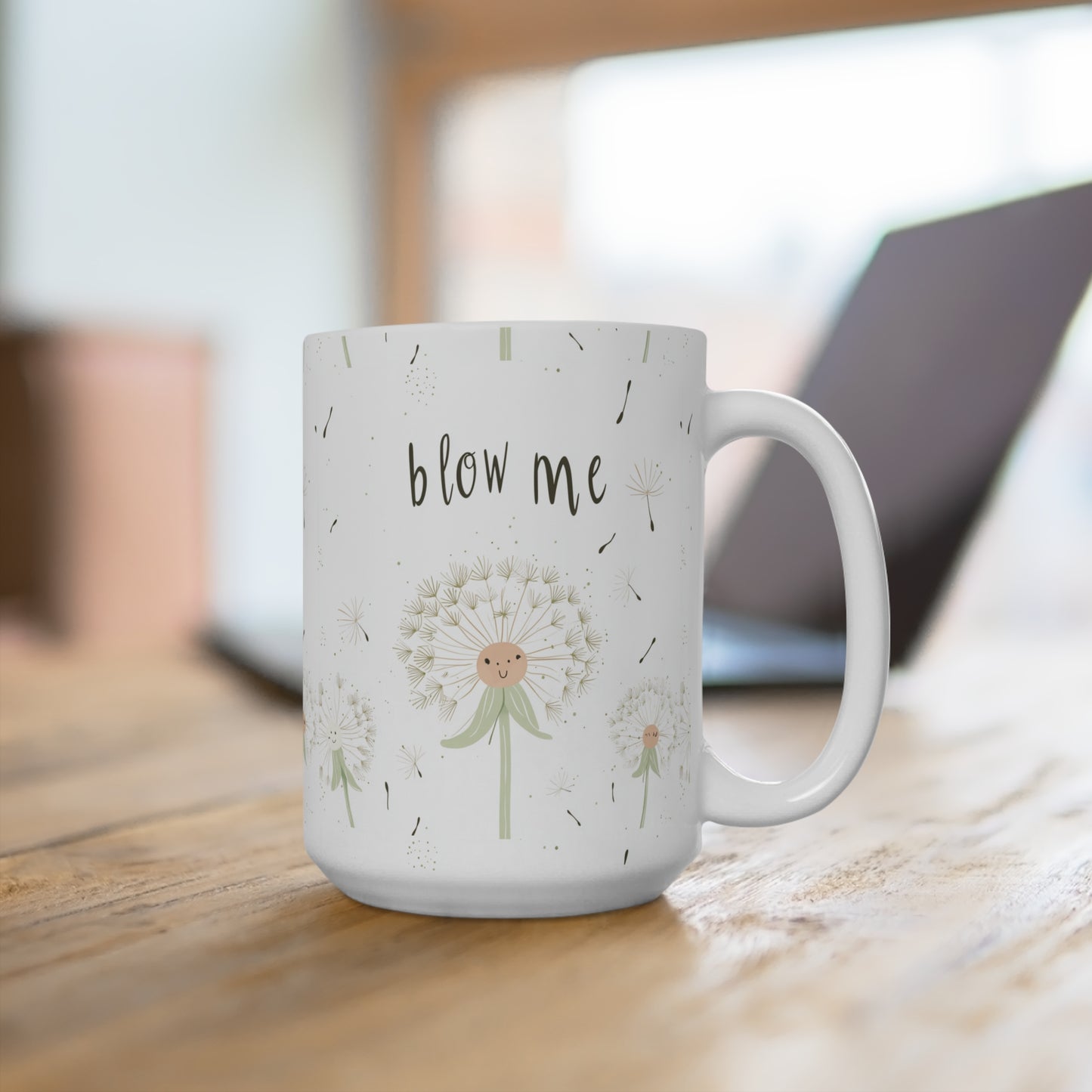 Blow Me funny Mug 15oz with a whimsical dandelion design on a wooden table