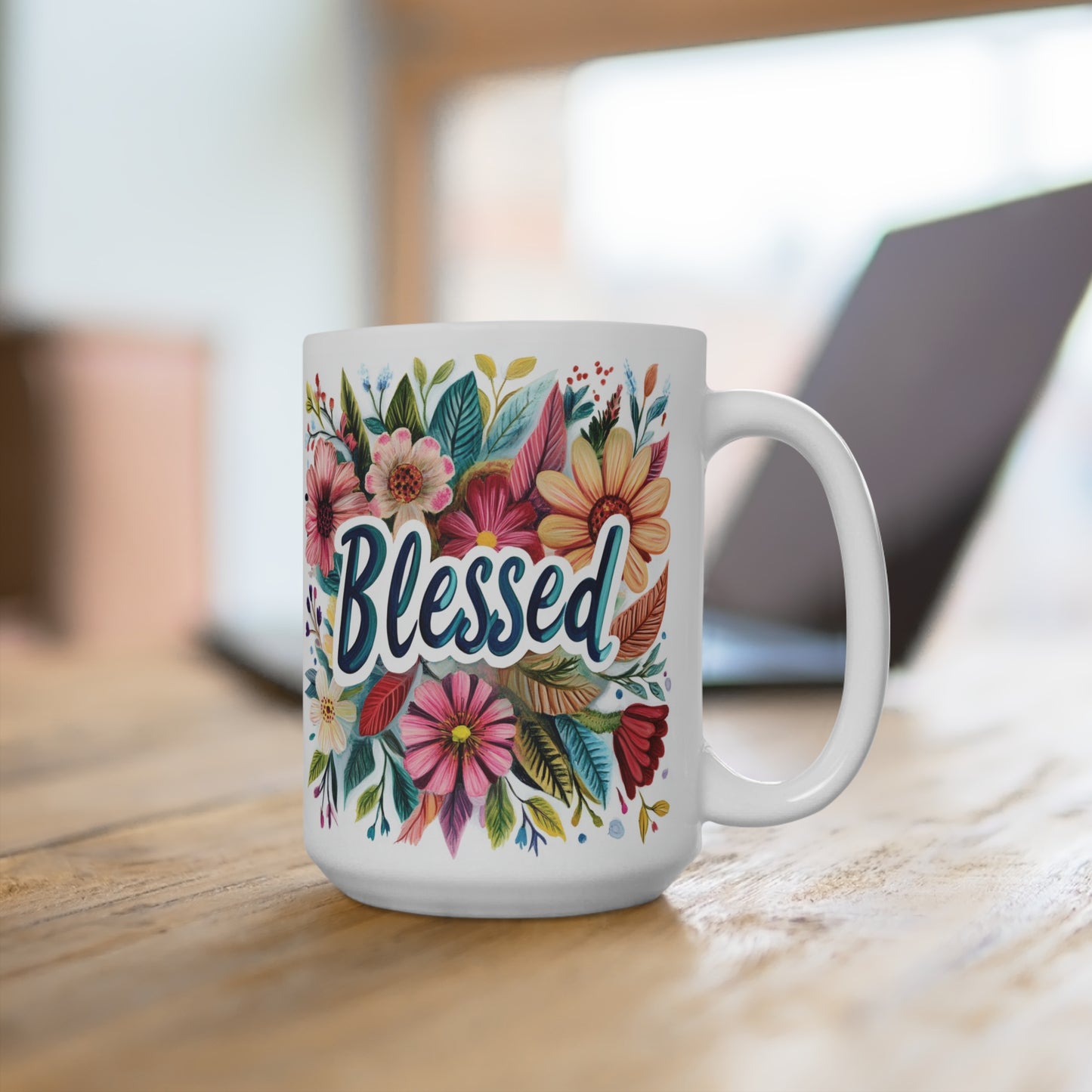 Printify white ceramic blessed coffee mug with colorful floral design on wooden desk near laptop