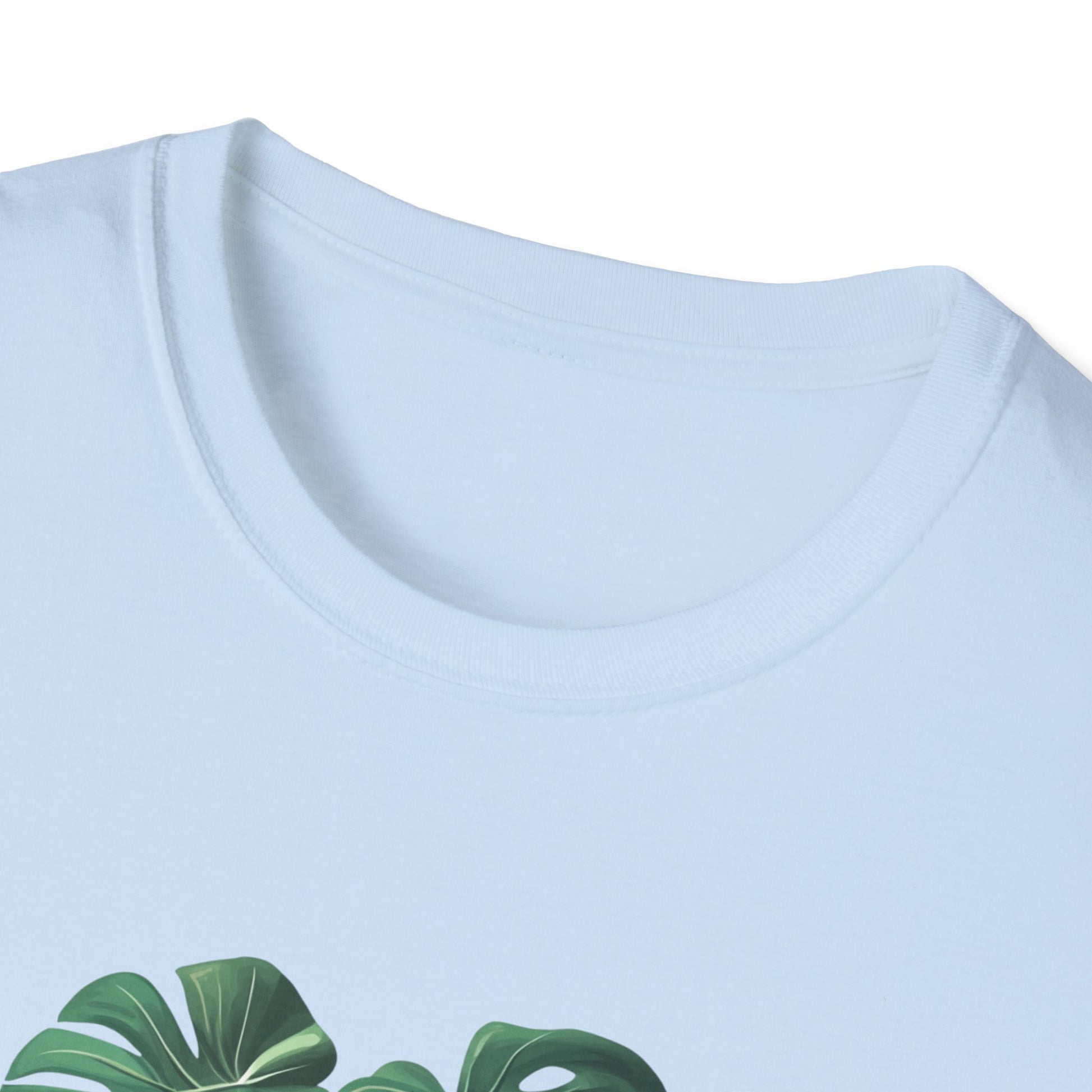 Close-up of a light blue monstera deliciosa t-shirt with vibrant leaf design and soft fabric