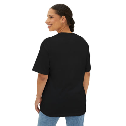 Model wearing an abundant vibe oversized tee in black, showcasing a relaxed fit and comfortable design